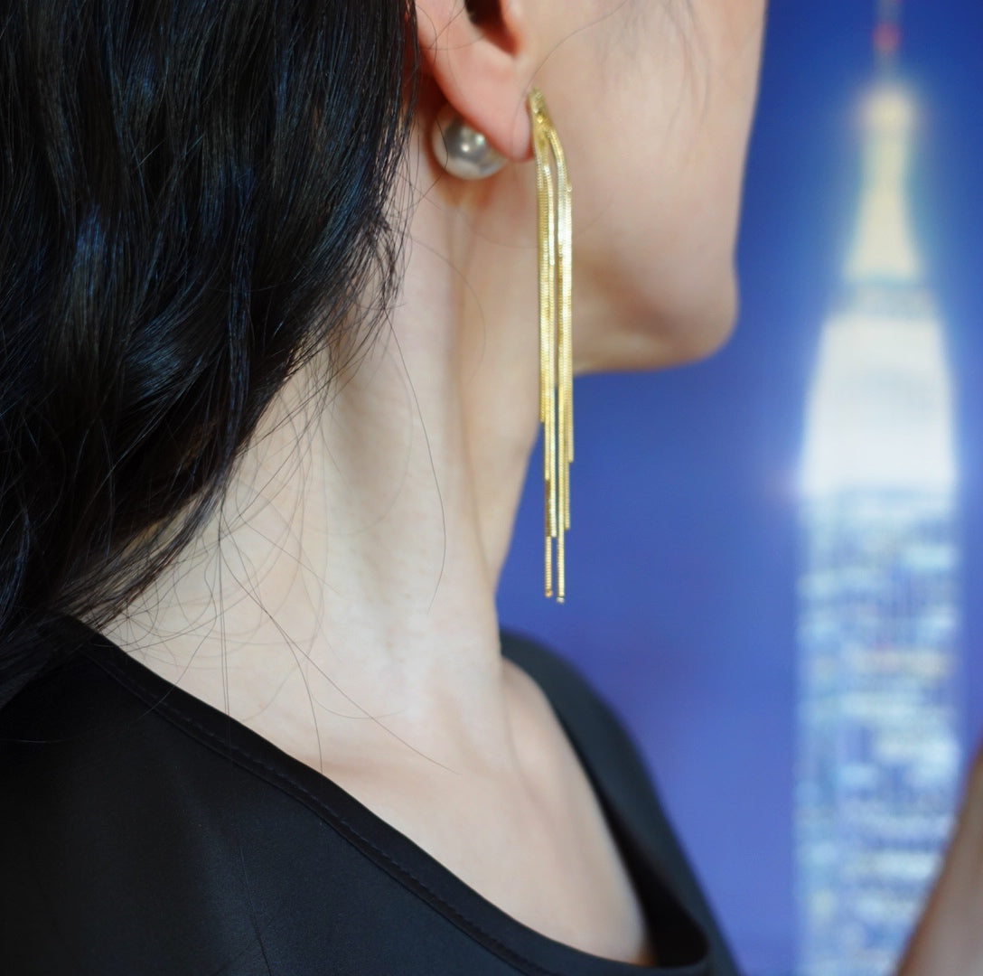 Enhance your style with Yun Boutique Tassel Stud Earrings. Features metal fringe adorned with faux pearl ear nut. Perfect for styling with modern and classic outfit for a chic and elegant look. 