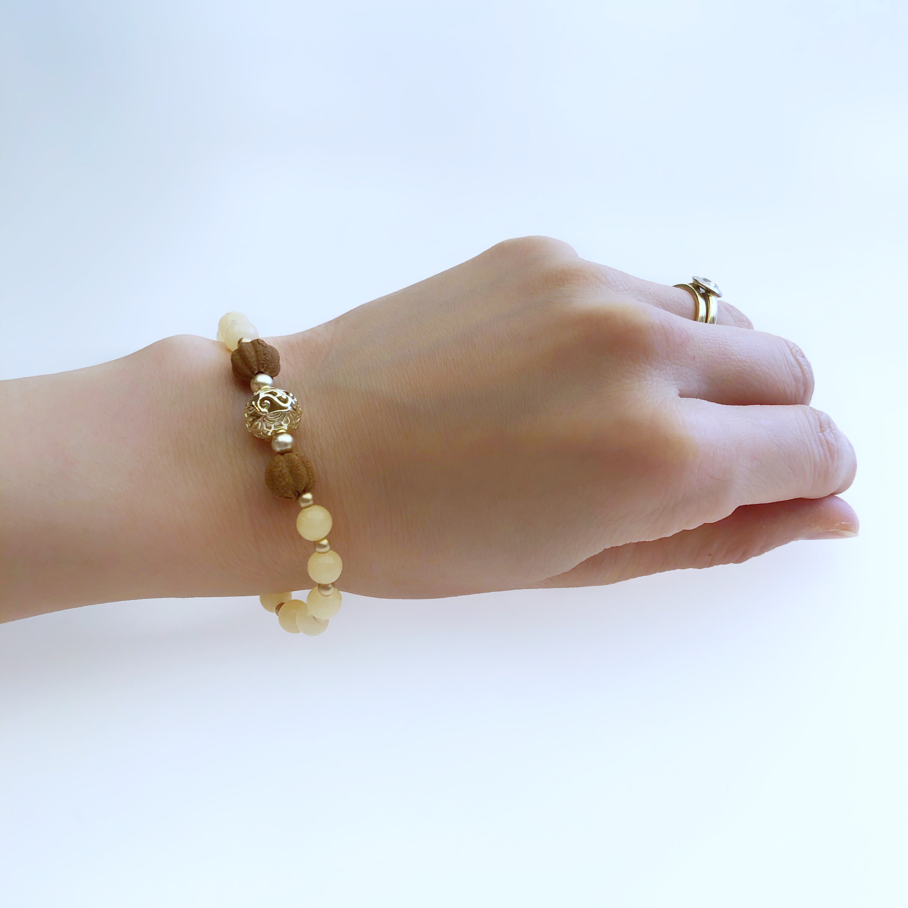 An Asian gold bracelet, each square link applied with a sign of the zodiac,  on a hook shaped clasp,